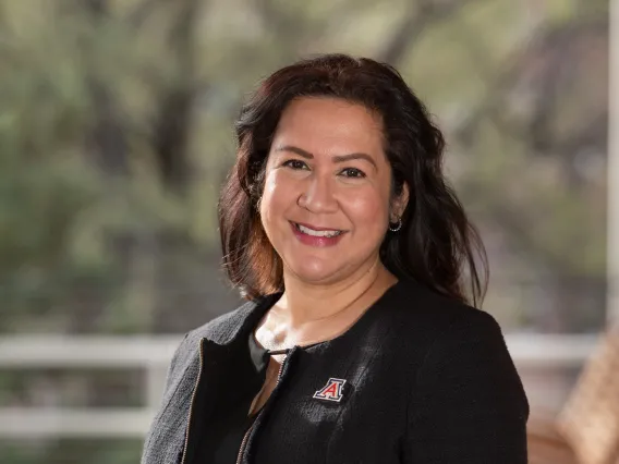 Picture of Annamarie Tellez, smiling in black shirt and black blazer