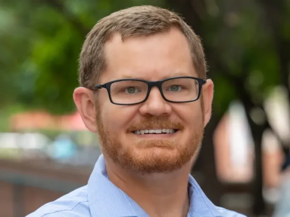headshot of Trevor Kvaran smiling directly at the camera