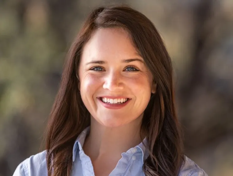 Emily Ross smiling for photo, wearing white collared shirt