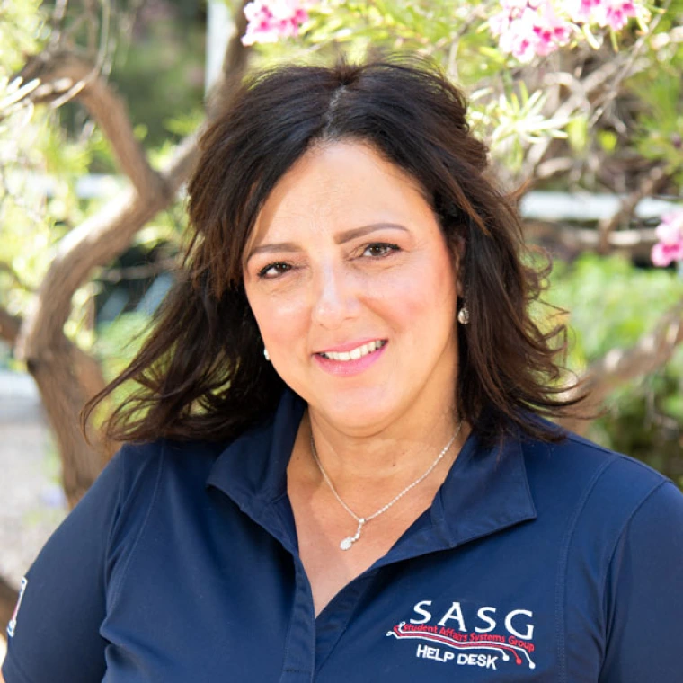 Licett Hernandez smiling for photo, wearing blue polo that reads "SASG"