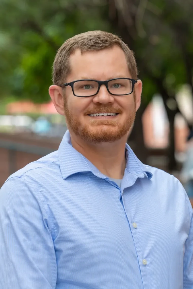 headshot of Trevor Kvaran smiling directly at the camera